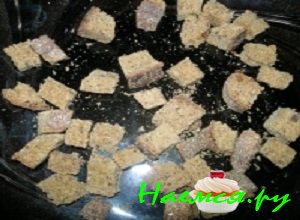 Ржаной хлеб порезать небольшими кубиками, выложить на противень и немного подсушить в духовой печи