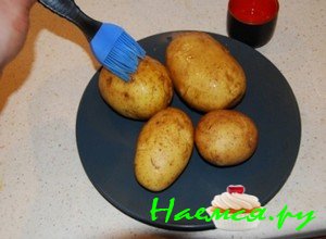 Помытую и просушенную картошку, положите на плоское блюдо и тщательно смажьте